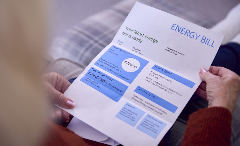 Close Up Of Senior Woman At Home Looking At USA Energy Bill During Cost Of Living Energy Crisis